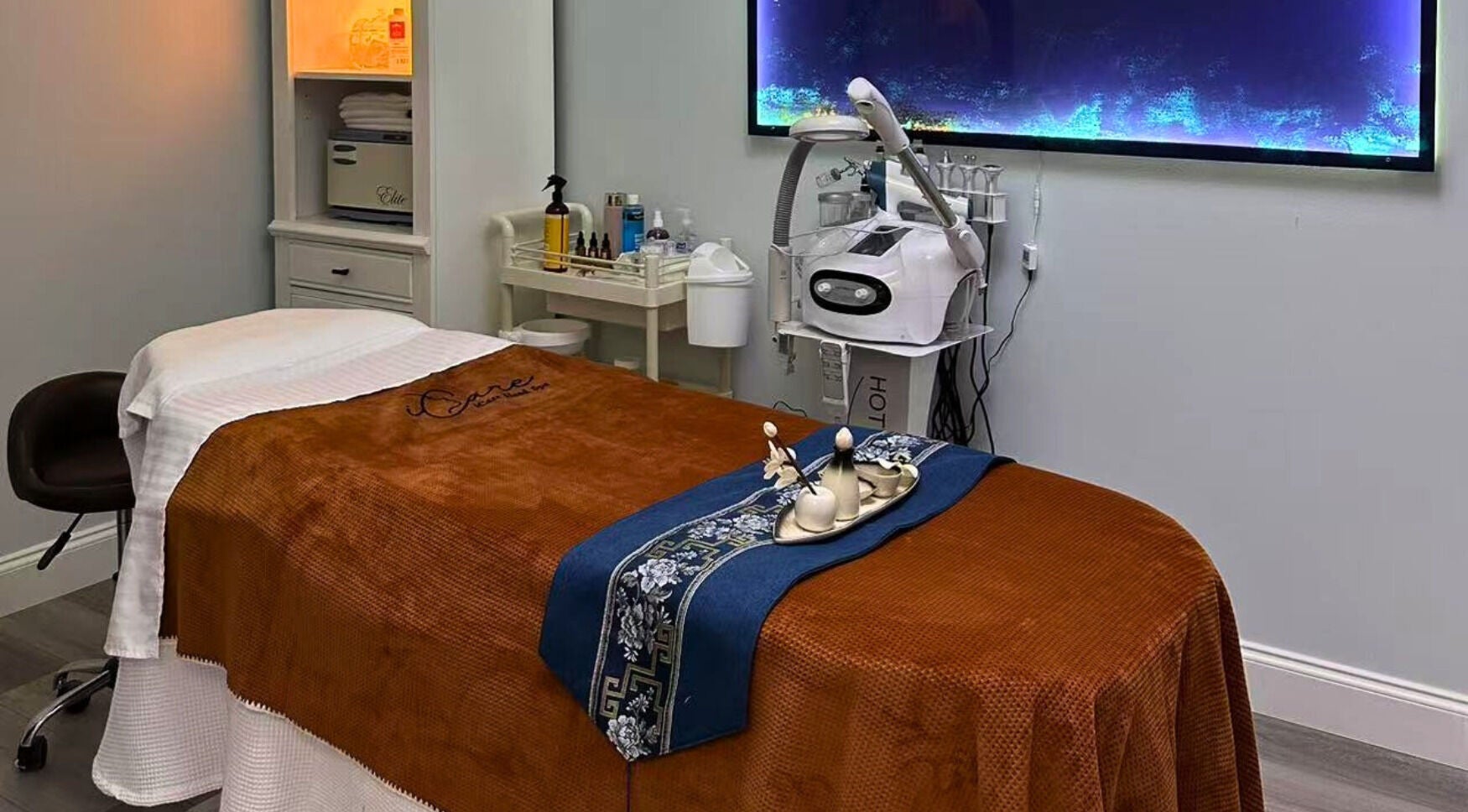 Relaxing spa room at iCare Head Spa, featuring a massage table and equipment in Seminole, Florida, US.