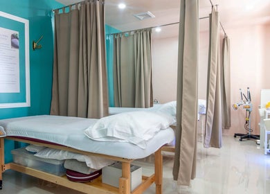 Calm treatment room at Acuholistic Health Center, Quezon City, Metro Manila, PH, featuring therapy beds.