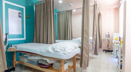 Calm treatment room at Acuholistic Health Center, Quezon City, Metro Manila, PH, featuring therapy beds.