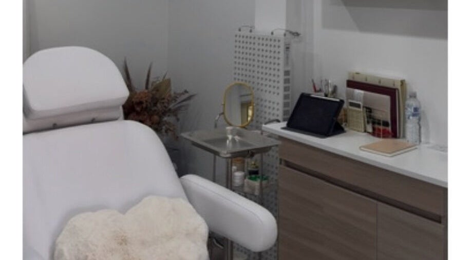 Elegant treatment room at Aesthetix Luxe, Punchbowl, New South Wales, AU, featuring a comfortable white chair.
