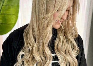 Blonde woman with flowing curls at Cherry Luxe & Co, Seaforth, New South Wales, AU.