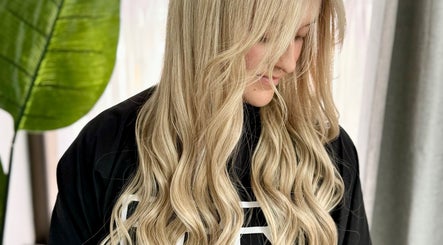 Blonde woman with flowing curls at Cherry Luxe & Co, Seaforth, New South Wales, AU.