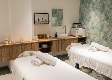 Relaxing massage room at AMIS @ The Embassy Hotel, Valletta, MT featuring two cozy beds and soothing decor.