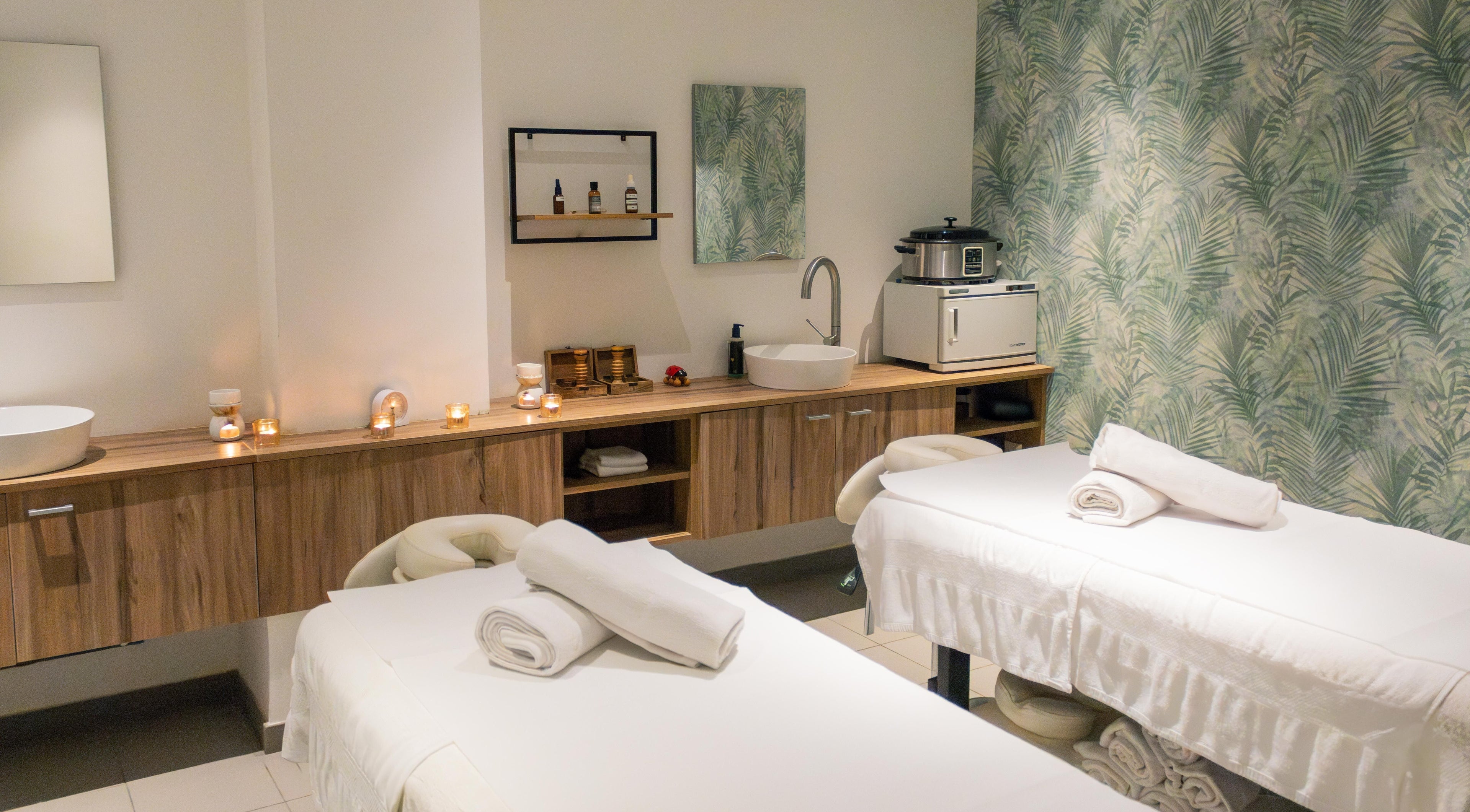 Relaxing massage room at AMIS @ The Embassy Hotel, Valletta, MT featuring two cozy beds and soothing decor.