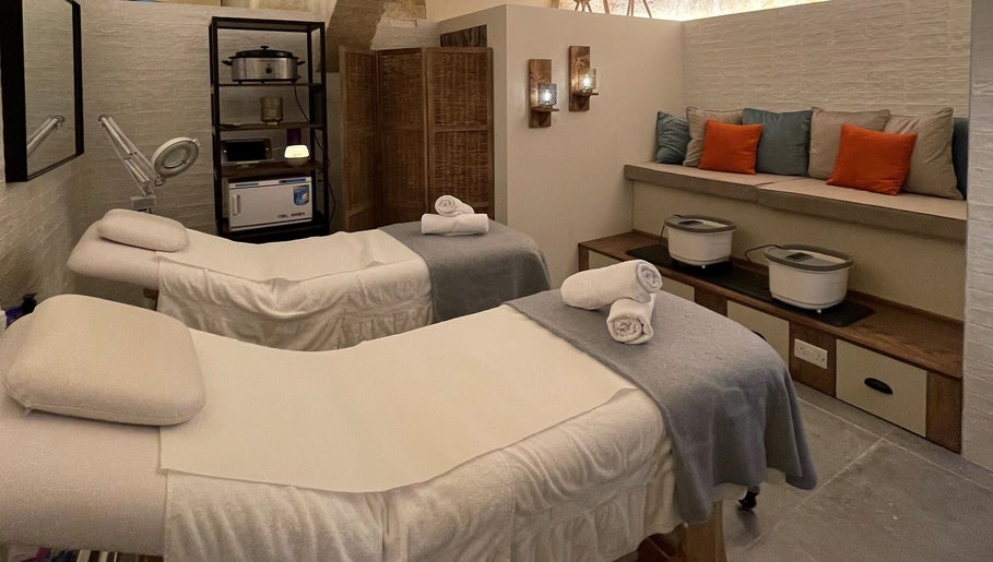 Serene massage room at Amis City Spa, Beauty & Hair Salon in Il-belt Valletta, MT with cozy white beds.
