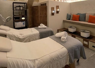 Serene massage room at Amis City Spa, Beauty & Hair Salon in Il-belt Valletta, MT with cozy white beds.