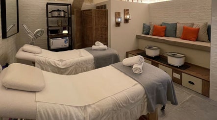 Serene massage room at Amis City Spa, Beauty & Hair Salon in Il-belt Valletta, MT with cozy white beds.