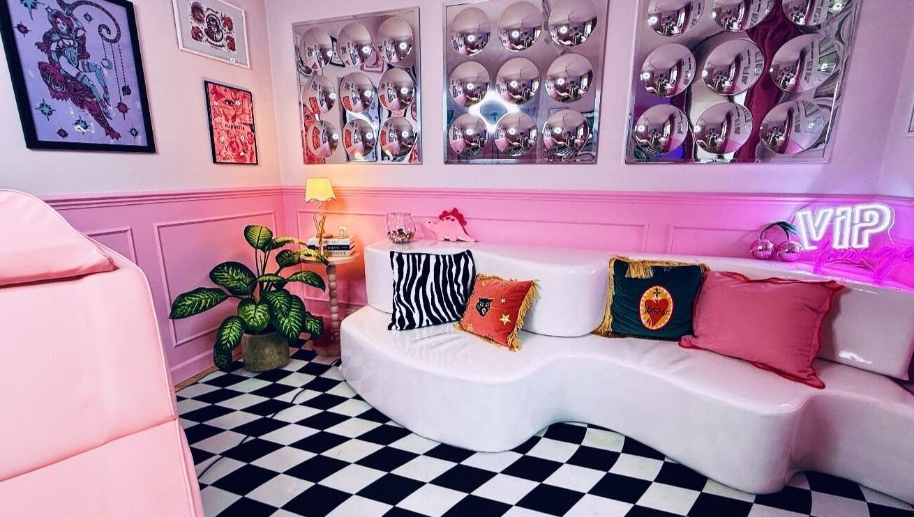Stylish lounge at Heartbreaker Aesthetics, Henfield, England, GB with pink decor and bold patterns.