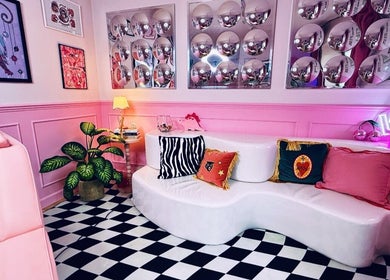 Stylish lounge at Heartbreaker Aesthetics, Henfield, England, GB with pink decor and bold patterns.