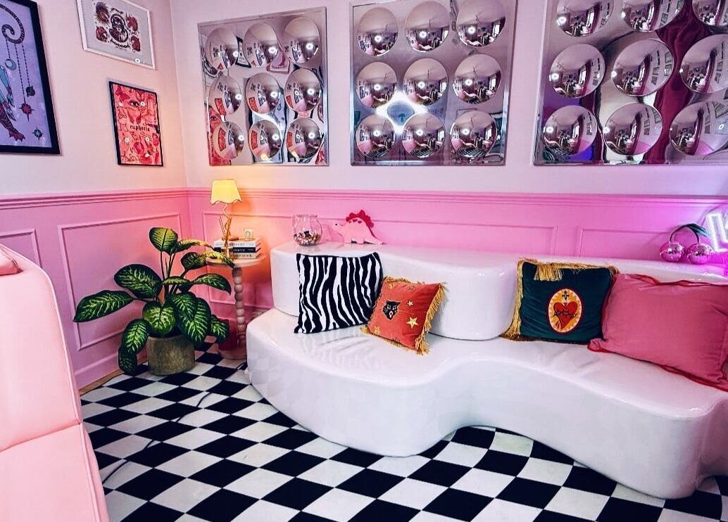 Stylish lounge at Heartbreaker Aesthetics, Henfield, England, GB with pink decor and bold patterns.