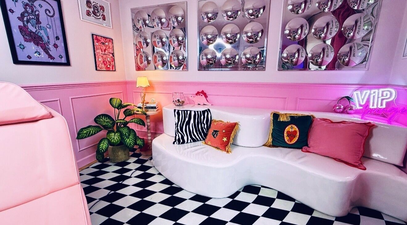 Stylish lounge at Heartbreaker Aesthetics, Henfield, England, GB with pink decor and bold patterns.