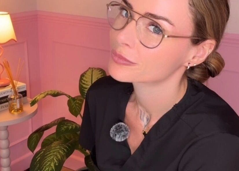 Woman in stylish glasses at Heartbreaker Aesthetics, Henfield, England, GB, relaxes in a chic corner.
