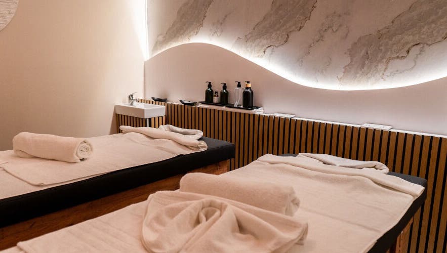 Elegant massage room with twin beds at éir Massage Studio, Tas-sliema, MT, featuring soothing decor and ambient lighting.