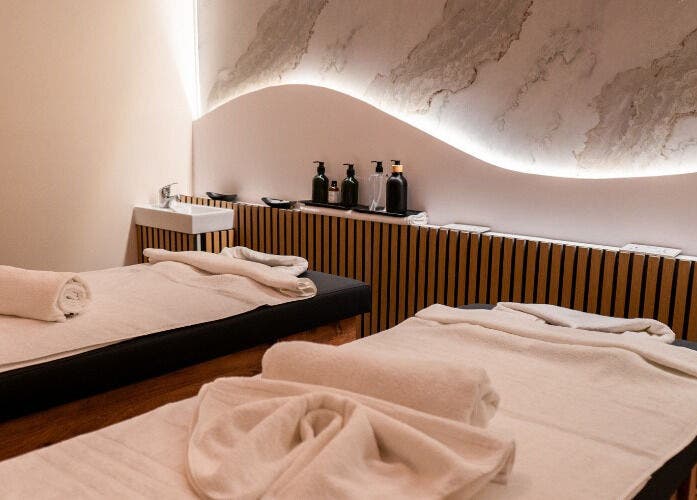 Elegant massage room with twin beds at éir Massage Studio, Tas-sliema, MT, featuring soothing decor and ambient lighting.