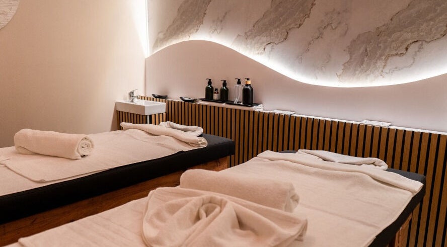 Elegant massage room with twin beds at éir Massage Studio, Tas-sliema, MT, featuring soothing decor and ambient lighting.