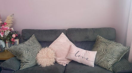 Inviting sofa with plush pillows in Radiant Nails, Llanelli, Cymru, GB. Perfect relaxation spot.