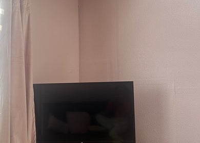 TV and curtains in a relaxing corner at Radiant Nails, Llanelli, Cymru, GB.