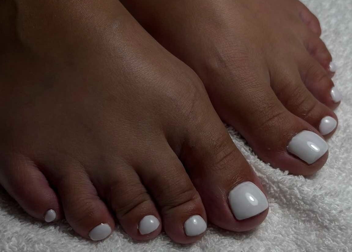 Witte gelakte teennagels bij MORRI in Sint-niklaas, Vlaams Gewest, BE voor ultieme voetverzorging.