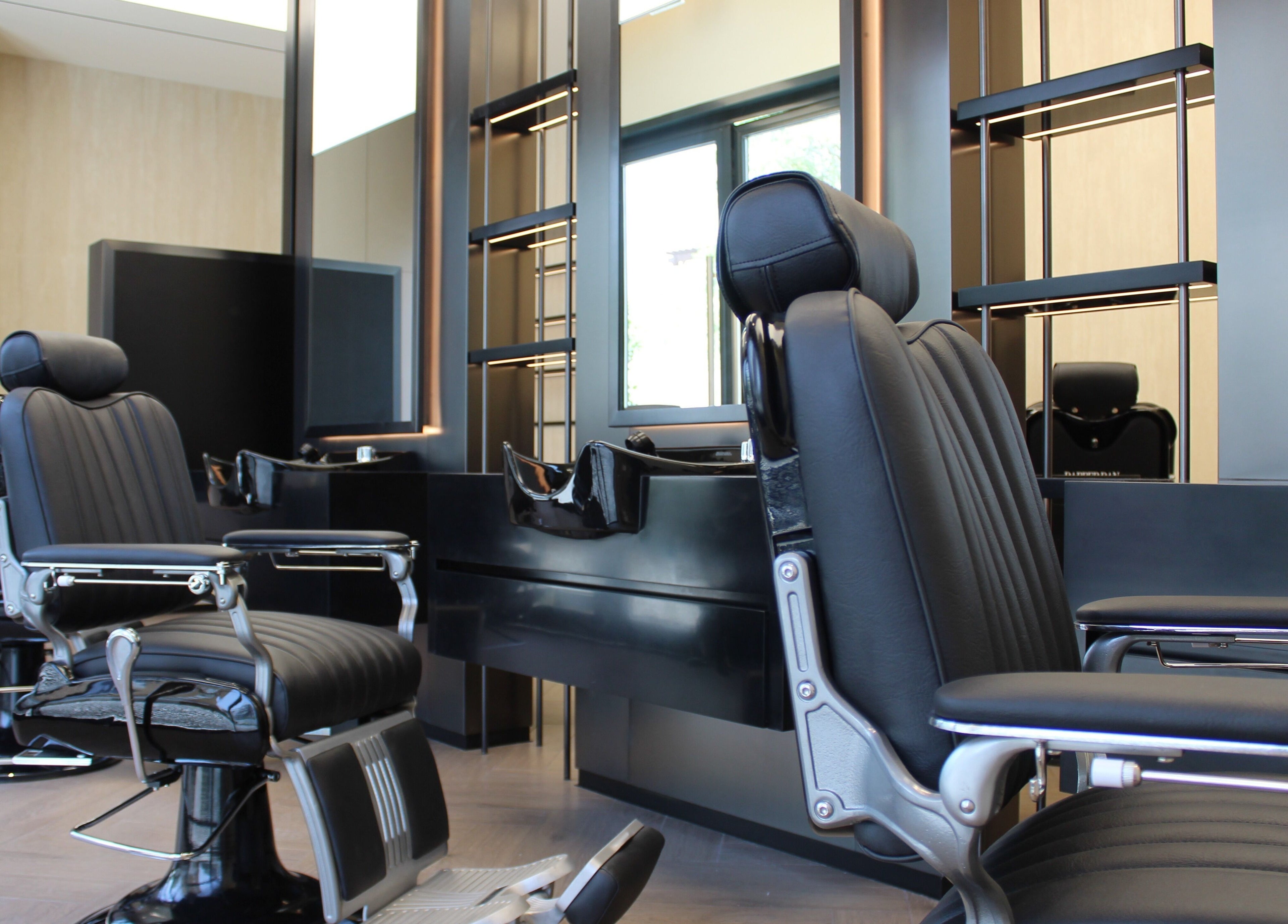 Luxurious barber chairs at Dapper Dan Barbershop, Dubai, Dubai, AE, showcasing stylish and modern interior.