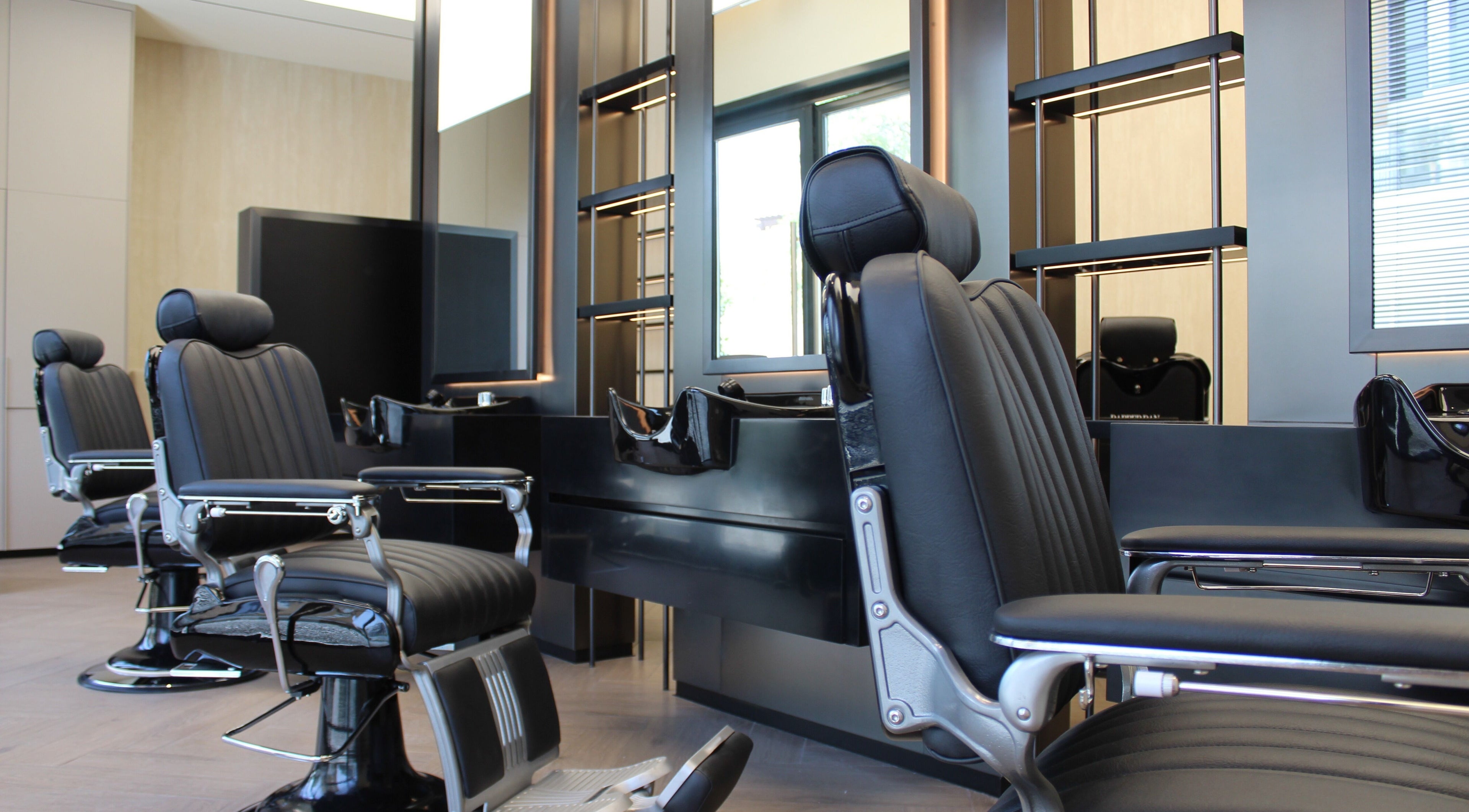 Luxurious barber chairs at Dapper Dan Barbershop, Dubai, Dubai, AE, showcasing stylish and modern interior.