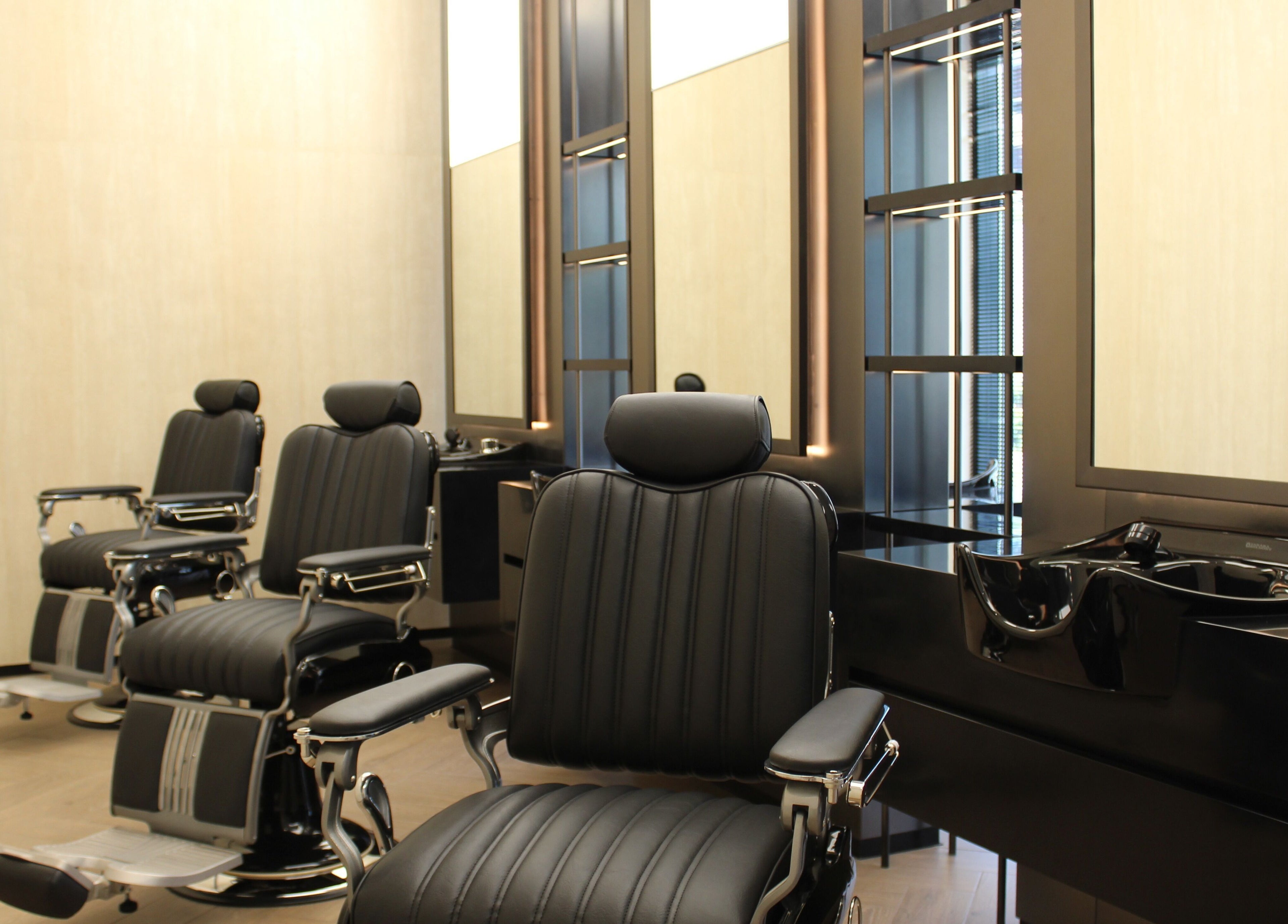 Modern barber chairs at Dapper Dan Barbershop, Dubai, Dubai, AE, showcasing luxury grooming aesthetics.
