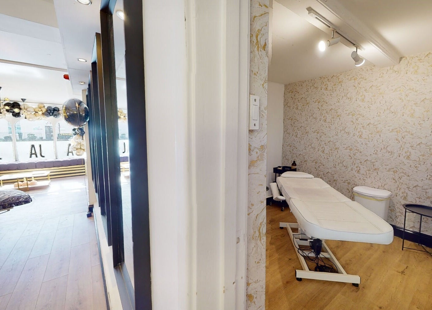 Interior of Mi Amor Aesthetics in Derby, England, featuring a treatment room and stylish decor.