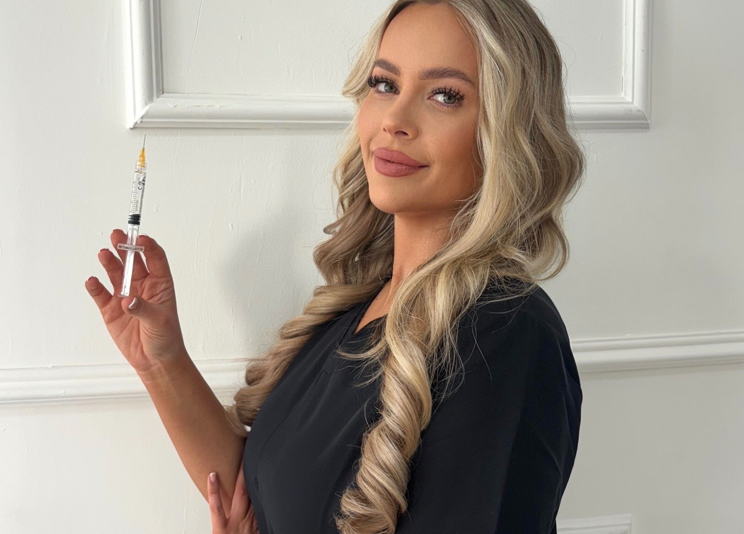 Beauty specialist at Mi Amor Aesthetics in Derby, England, showcasing expertise with a syringe.