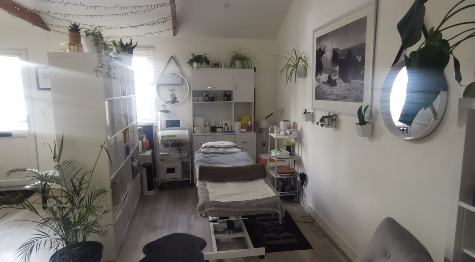 Relaxing treatment room at Halo Fine Line Ink Inside BWB in Colchester, England, GB. Modern decor with plants.