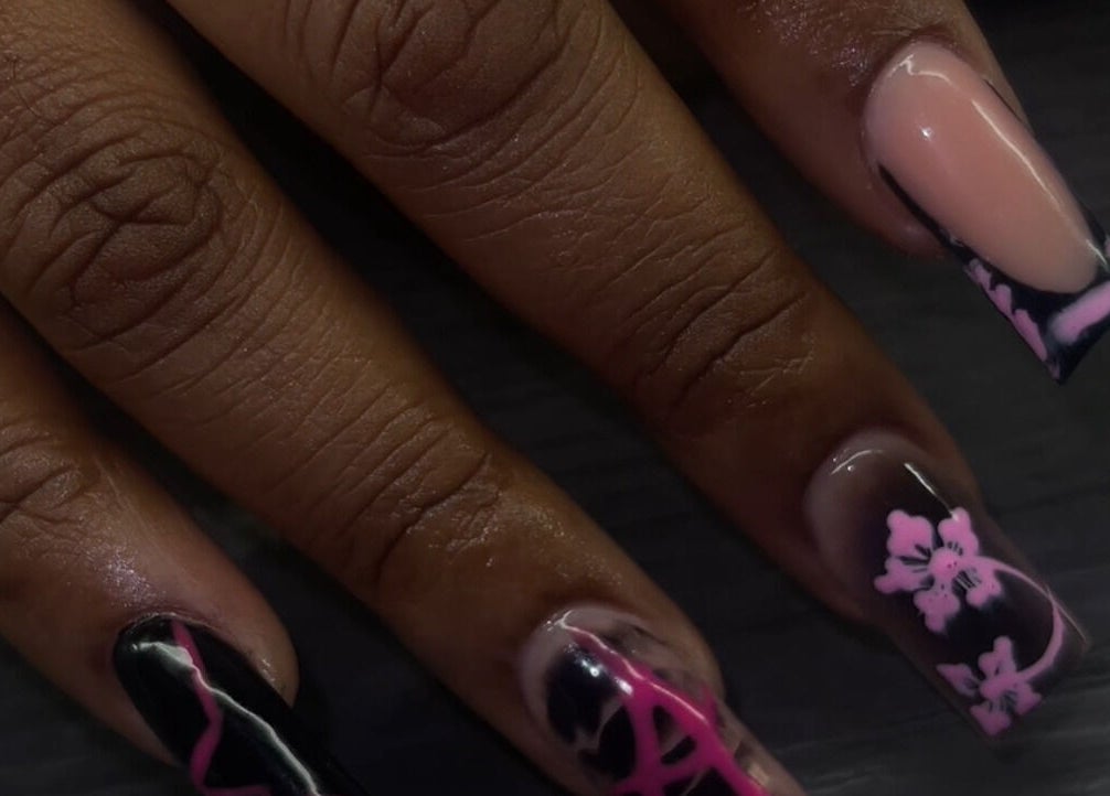 Elegant floral nail art by Reaper Nails in Marietta, Georgia, US. Features black and pink designs.