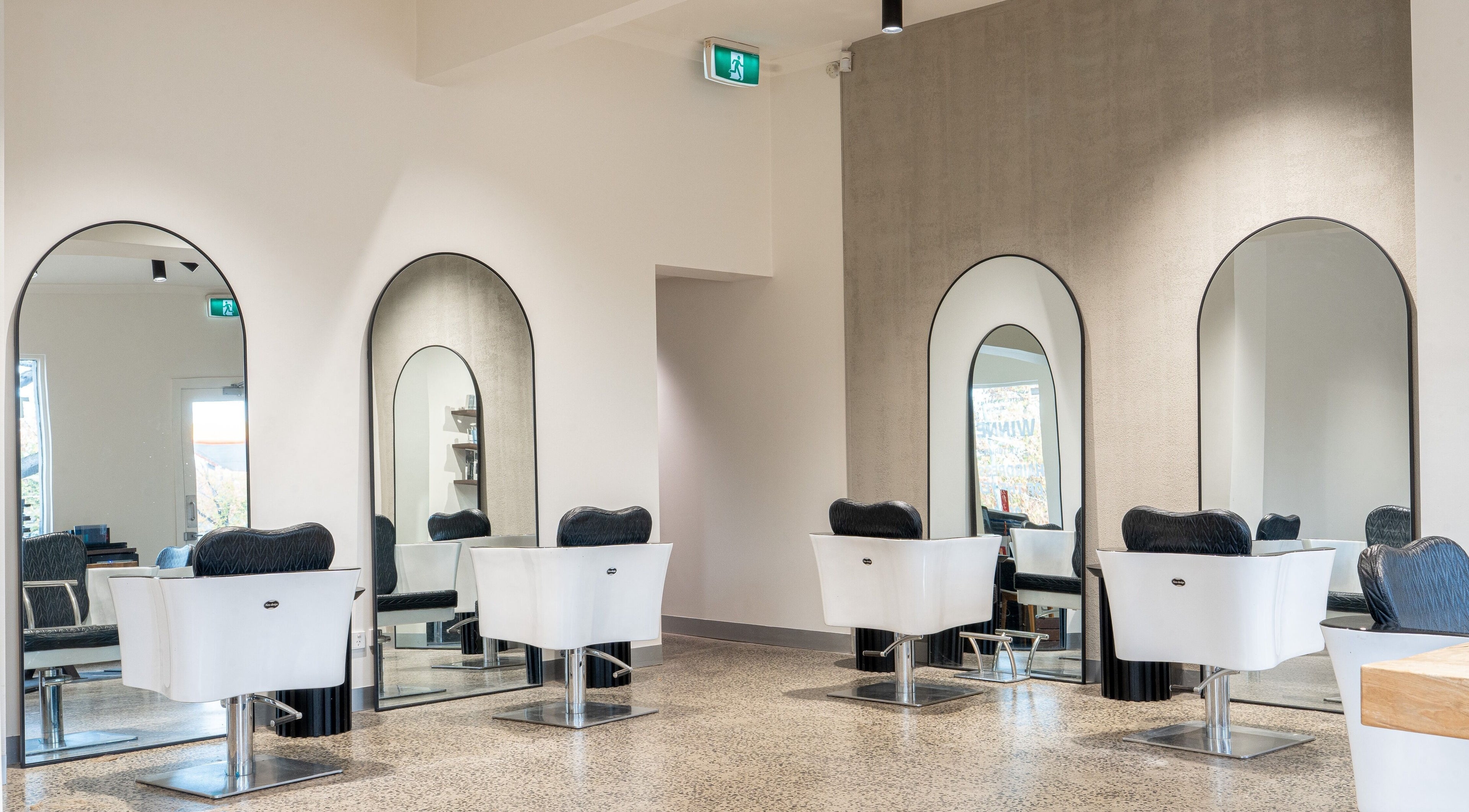 Stylish salon chairs at Vision Hair Studio, Melbourne, Victoria, AU, offering professional hair services.