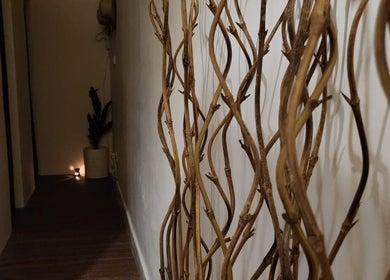 Warm and inviting hallway at Khonó Spa, Bali, Bali, ID with natural decor and soft lighting.