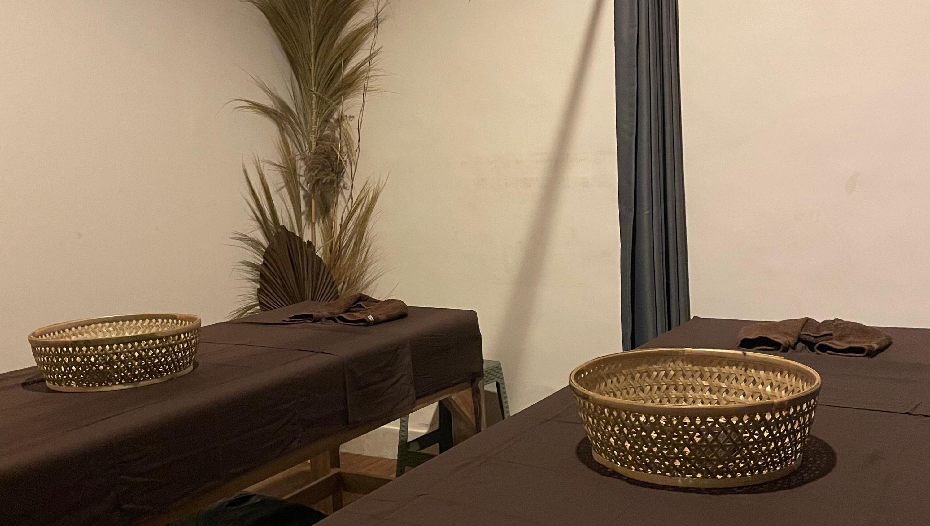 Relaxing treatment room at Khonó Spa, Bali, Bali, ID, featuring massage tables and calming decor.