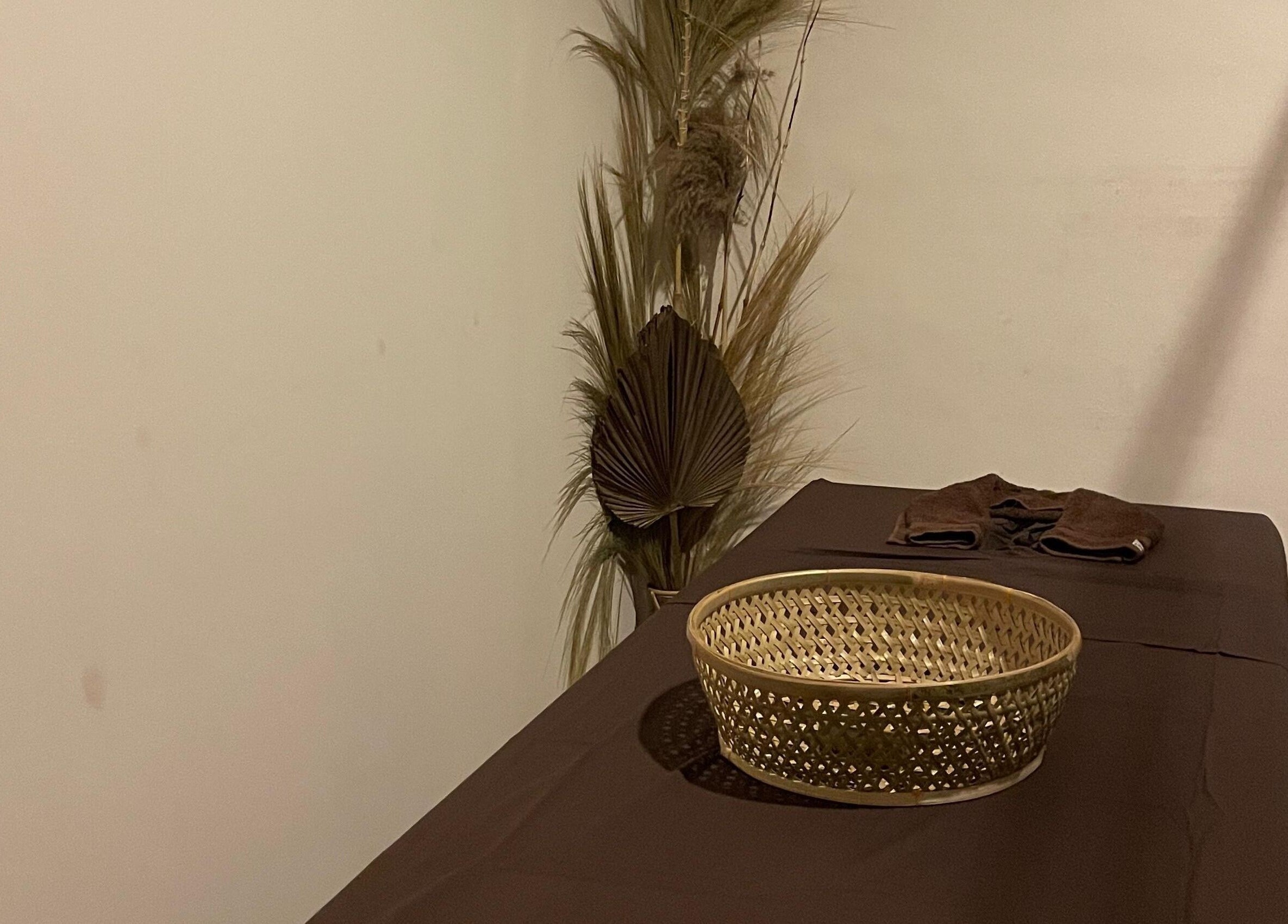 Serene massage room at Khonó Spa, Bali, Bali, ID with a calming decor and wicker basket.