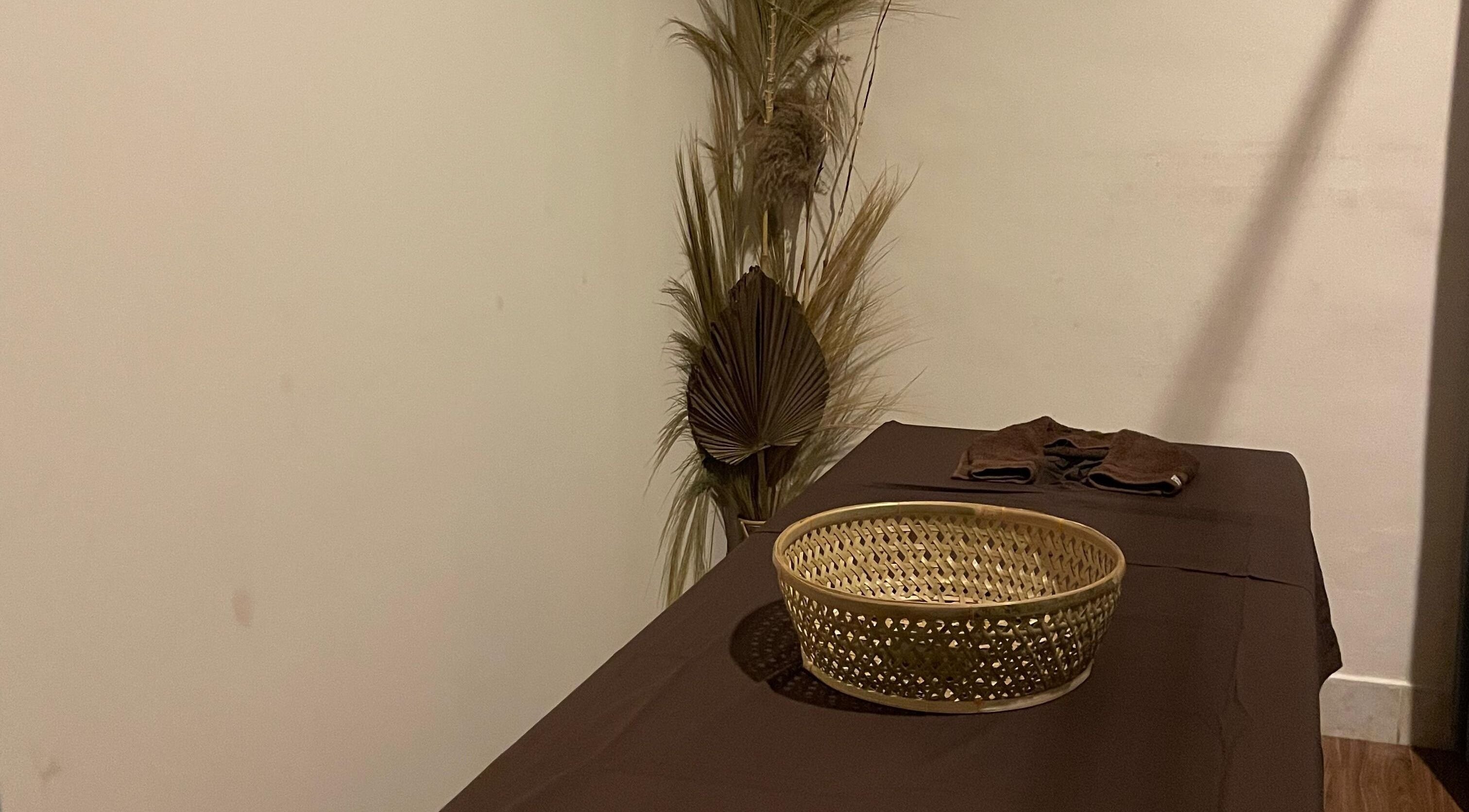 Serene massage room at Khonó Spa, Bali, Bali, ID with a calming decor and wicker basket.