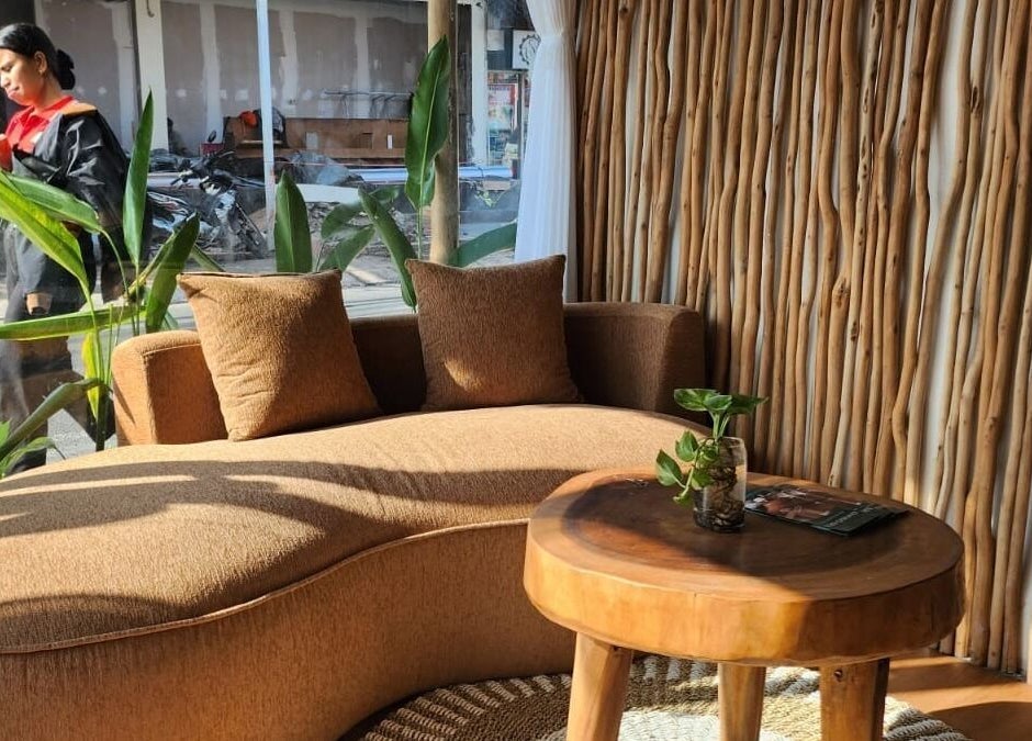 Elegant seating area in Khonó Spa, Bali, Bali, ID, featuring plush sofa and rustic decor.