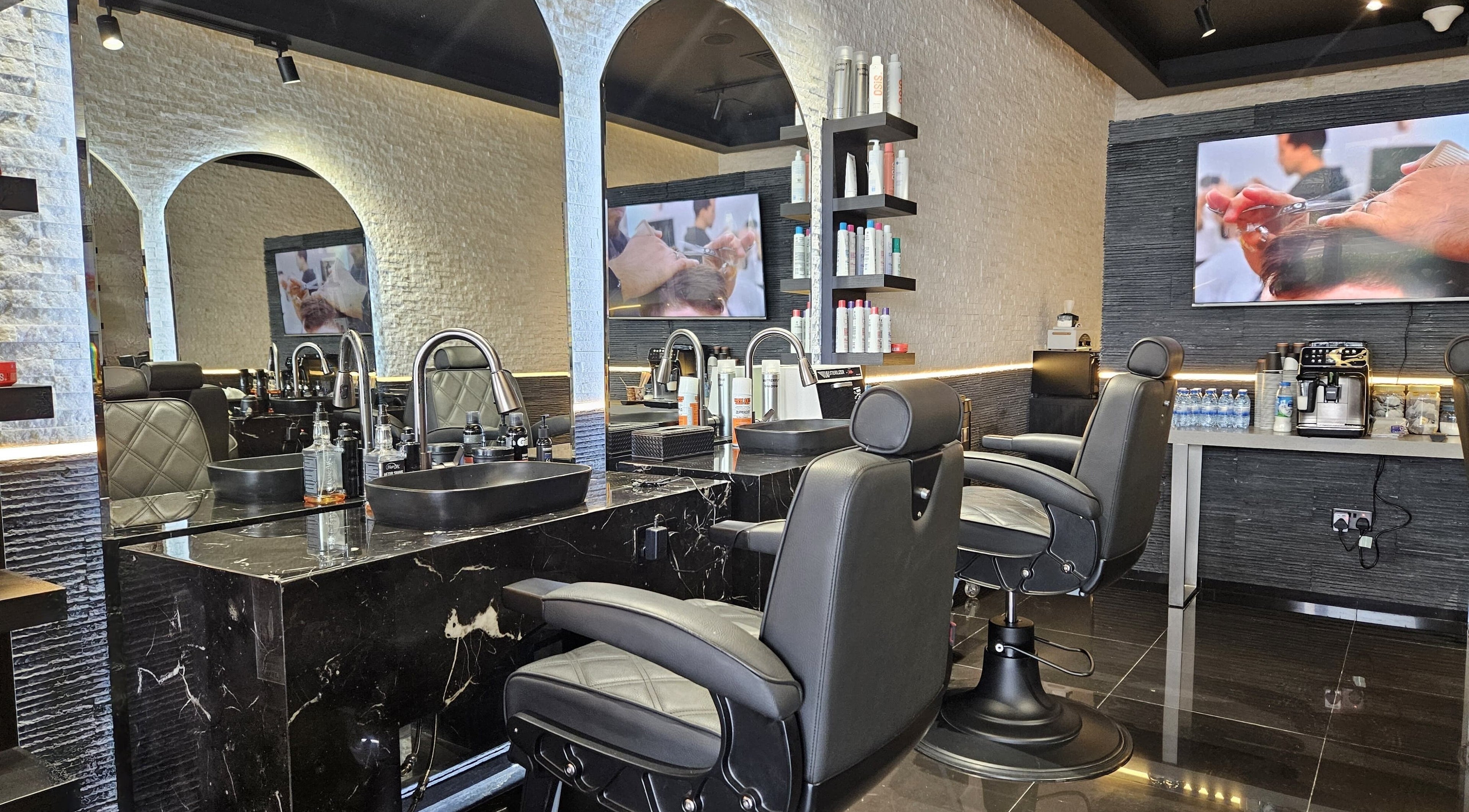 Elegant interior of Cuts Gents Salon in Dubai, Dubai, AE with modern styling chairs and mirrors.