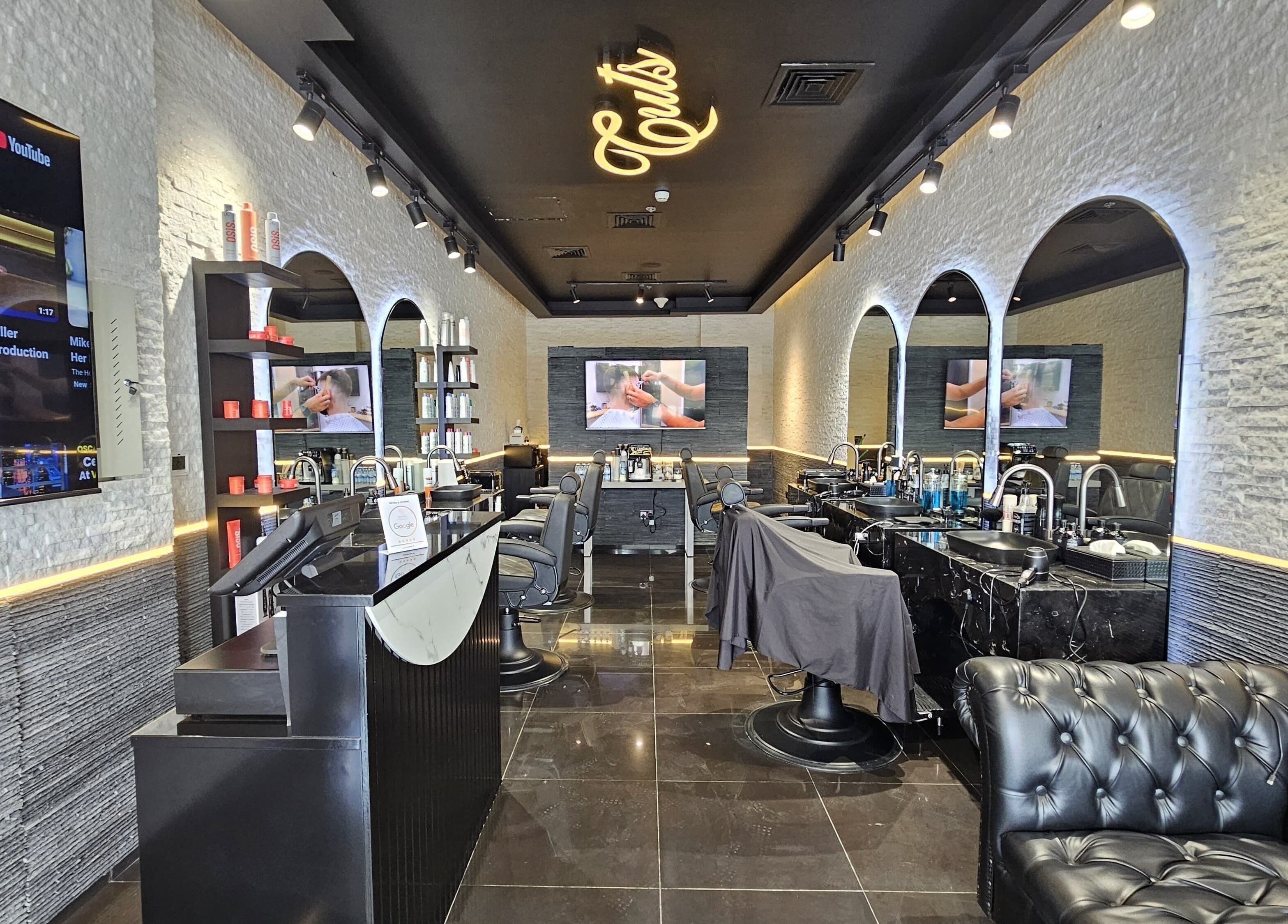 Chic interior of Cuts Gents Salon in Dubai, Dubai, AE with modern decor and comfortable seating.