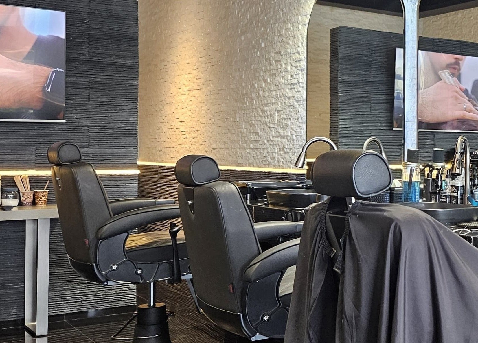Chic interior of Cuts Gents Salon in Dubai, Dubai, AE featuring sleek barber chairs and modern fixtures.