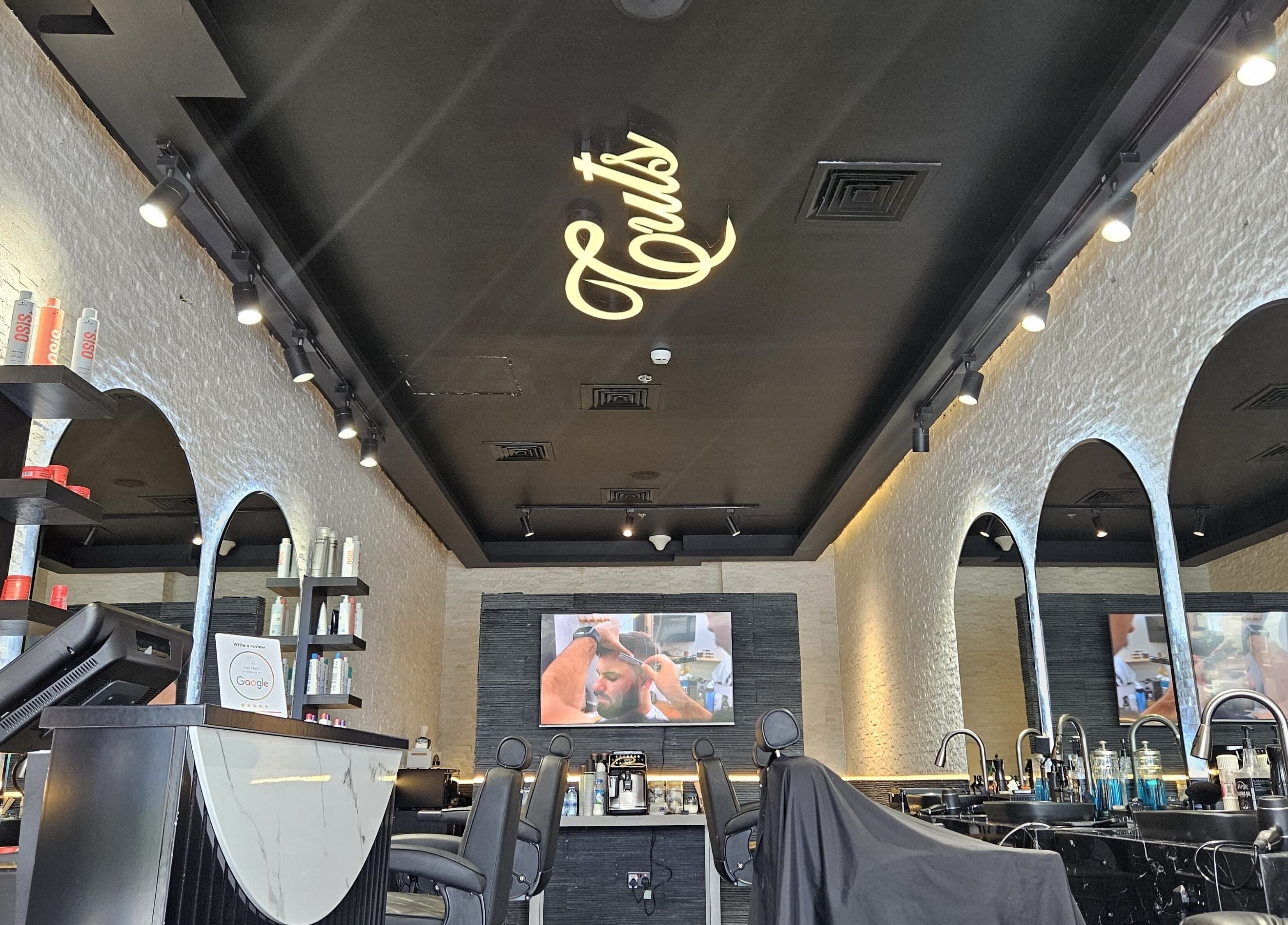 Elegant interior of Cuts Gents Salon in Dubai, Dubai, AE showcasing stylish barber chairs and modern decor.