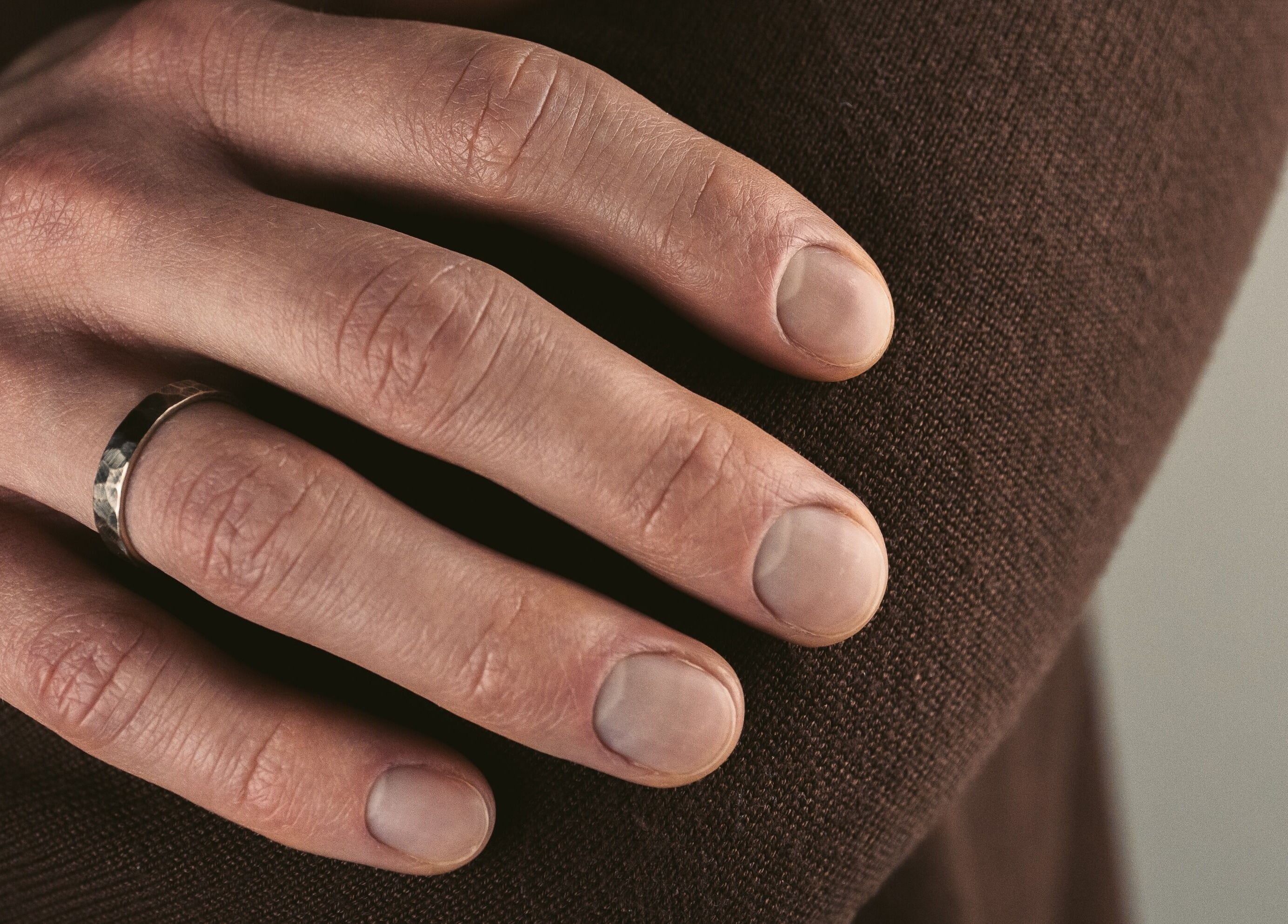 Close-up of a hand with a ring at Nails Murr Luxe - Manicure Salon in Canary Wharf, London, England, GB.