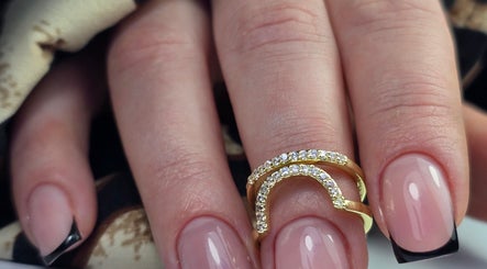 Elegant black tip nails with gold ring at SWorld Nails, Kingston Upon Hull, Anglia, GB.
