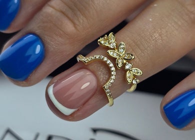 Elegant manicured nails with gold rings at SWorld Nails, Kingston Upon Hull, Anglia, GB.