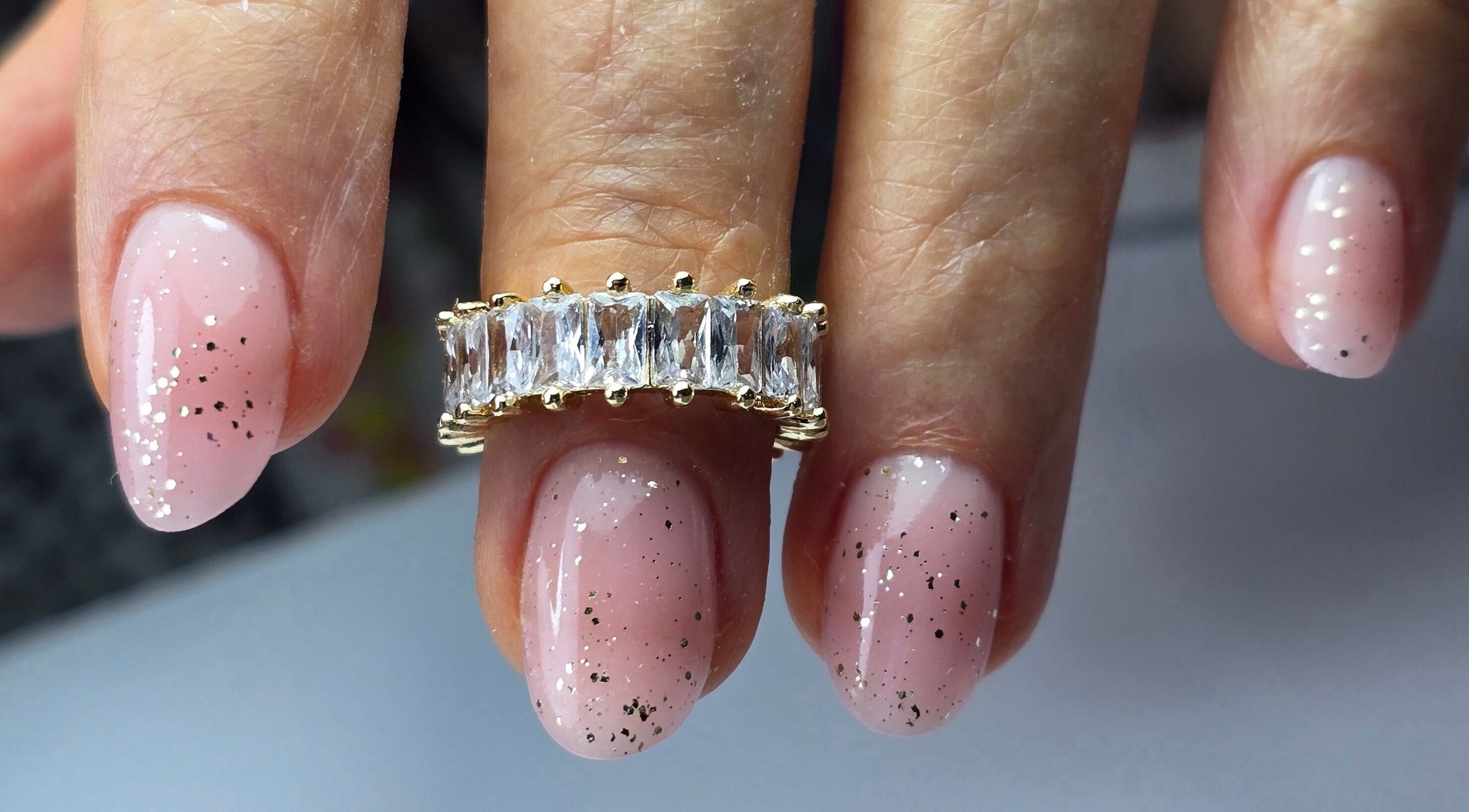 Glittery pink nails with a ring at SWorld Nails, Kingston Upon Hull, Anglia, GB.