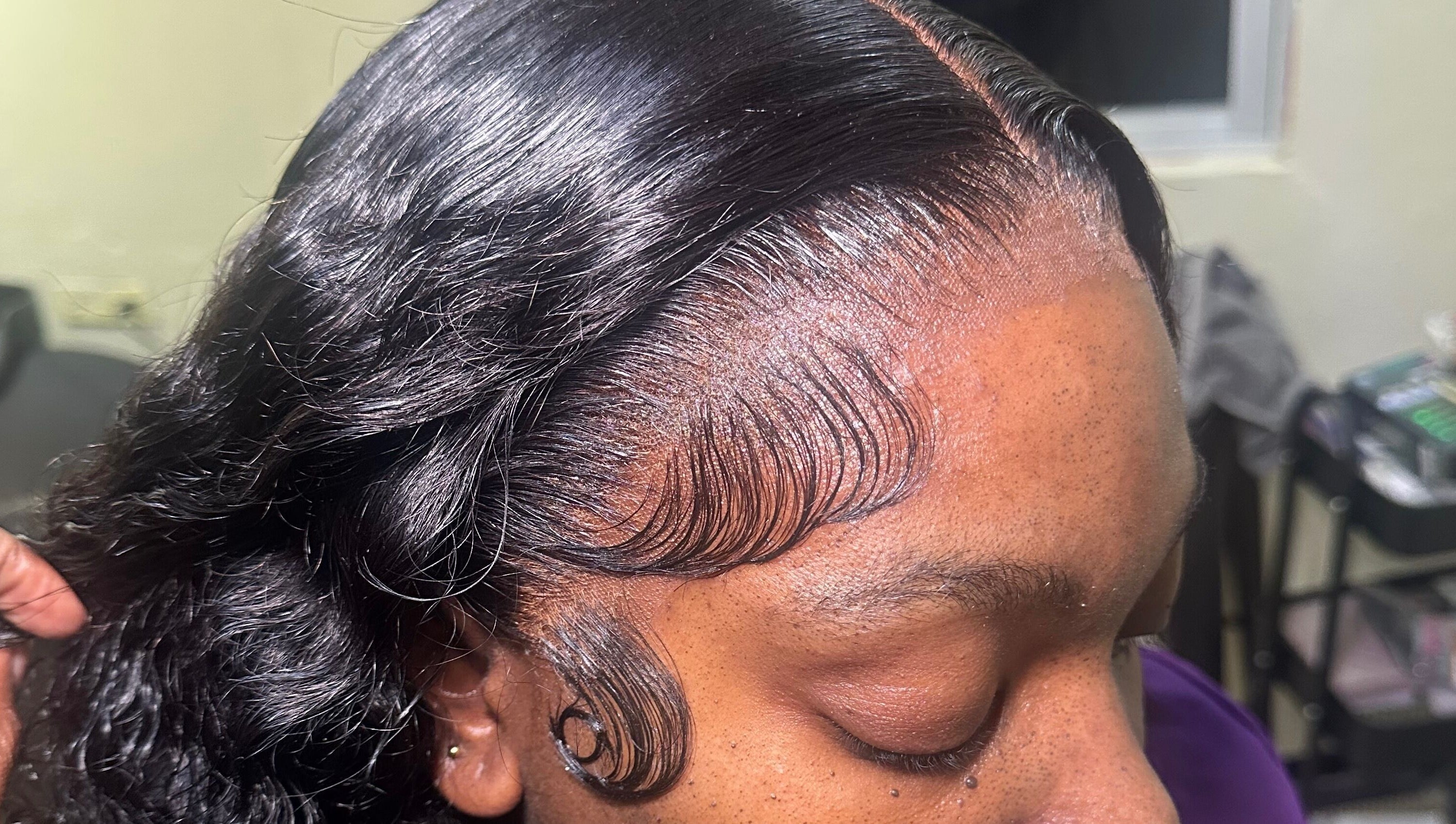 Close-up of a sleek hairstyle with detailed edges at Beauti Cabin, Kingston, St. Andrew Parish, JM.