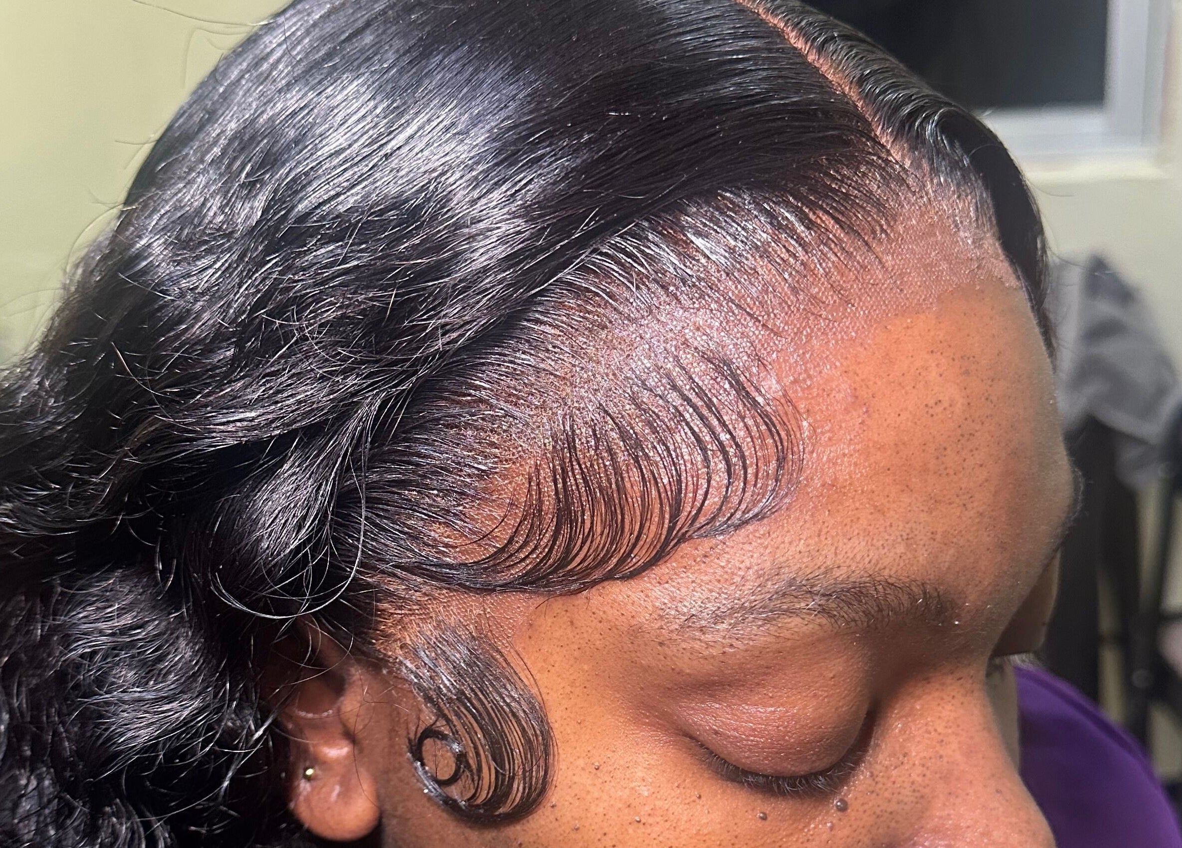 Close-up of a sleek hairstyle with detailed edges at Beauti Cabin, Kingston, St. Andrew Parish, JM.