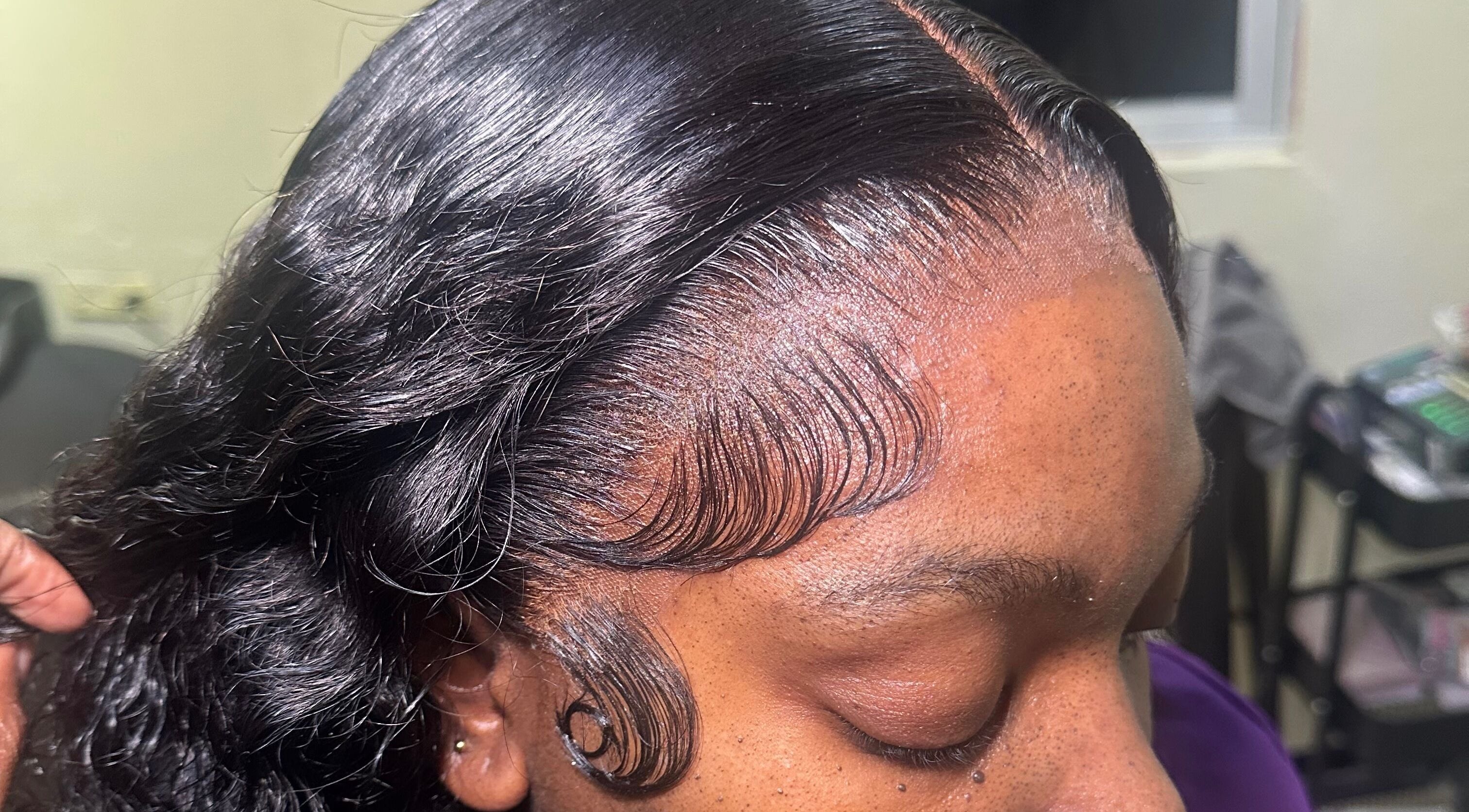 Close-up of a sleek hairstyle with detailed edges at Beauti Cabin, Kingston, St. Andrew Parish, JM.