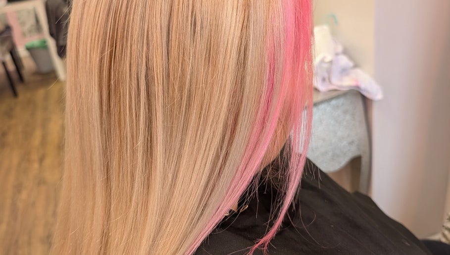 Stylish pink highlights on blonde hair at Twisted Friction @ Strands Studio, Sheffield, England, GB.