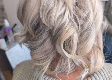 Blonde wavy hairstyle at Twisted Friction @ Strands Studio, Sheffield, England, GB. Elegant salon ambiance.