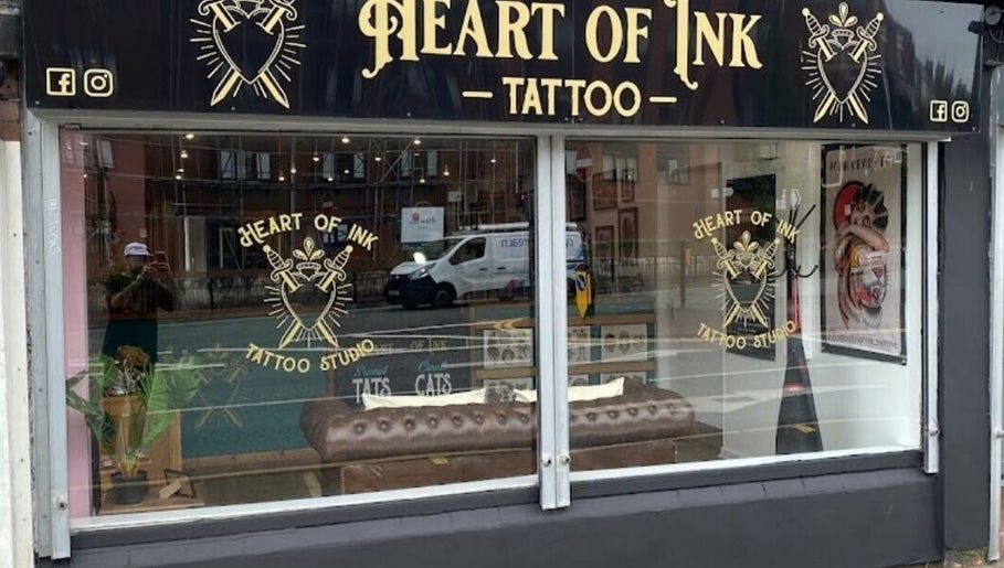 Loz The Hat Tattoo And Piercing's artistic windowfront in Ashton-in-Makerfield, England displays their unique style.
