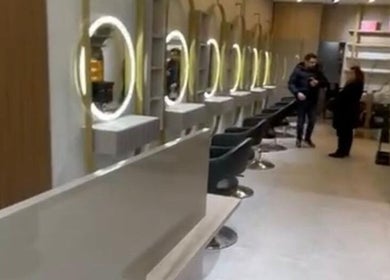 Modern interior of Salon Charles Malek, Naqqache, Jabal Lubnan, LB with sleek styling stations and illuminated mirrors.